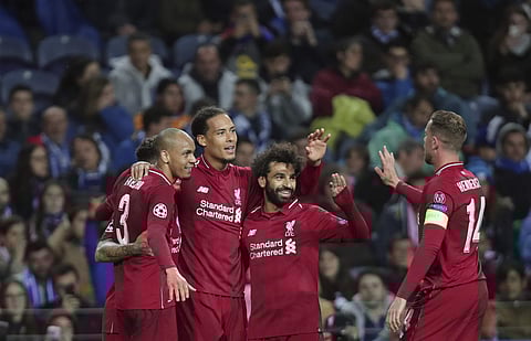 Liverpool's Virgil van Dijk celebrates with teammates after scoring his side's fourth goal during the Champions League quarterfinals. (File photo | AP)