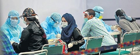 Medical workers screen passengers at Delhi’s IGI Airport | file