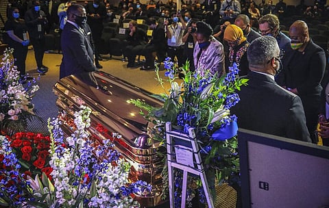 Members of the Congressional Black Caucus, at right, including Rep. Sheila Jackson-Lee, left, wearing blue face mask, U.S. Rep. Ilhan Omar, second from left, and U.S. Rep. Ayanna Pressley, right, stand at the casket of George Floyd before a memorial servi