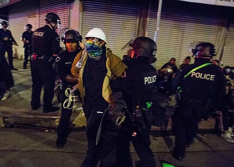 Police officers arrest a demonstator Sunday, May 31, 2020, in Los Angeles, during a protest over the death of George Floyd, who died May 25 after he was pinned at the neck by a Minneapolis police officer. (Photo | AP)