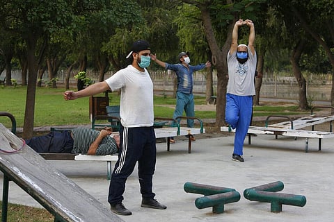 People exercise in a park in Lahore, Pakistan, Friday, June 5, 2020. Government of Pakistan's Punjab province has reopened parks in different cities of the province including Lahore amid coronavirus outbreak. (Photo | AP)
