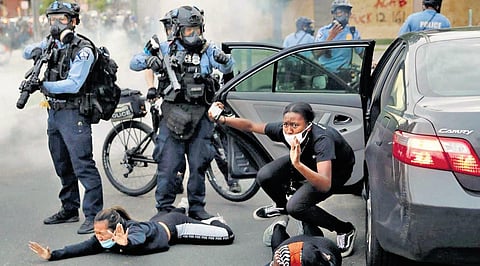 Police ordering protesters to the ground in Minneapolis following the death of George Floyd
