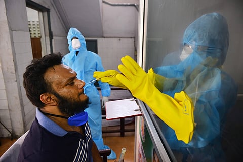 Health workers busy taking nosal swab samples from a man or COVID-19 test at a Public Health Laboratory and Health Care Center at Egmore in Chennai. (Photo | Debadatta Mallick/EPS)