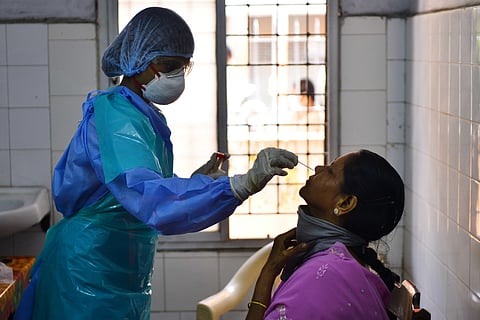Health workers busy taking nosal swab samples from a woman or COVID-19 test at a Public Health Laboratory and Health Care Center at Egmore in Chennai. (Photo | Debadatta Mallick/EPS)