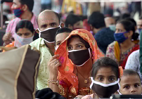 Migrants from Rajasthan wait to board a special train to reach Jodhpur at Central railway station in Chennai on Friday. (Photo | Martin Louis/EPS)