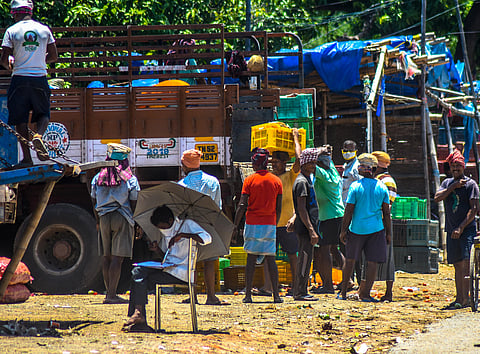Transport labourers on their workside ignoring social distance norms most of them seen without face mask at Unit-1 market in Bhubaneswar on Thursday. (Photo | Biswanath Swain/EPS)