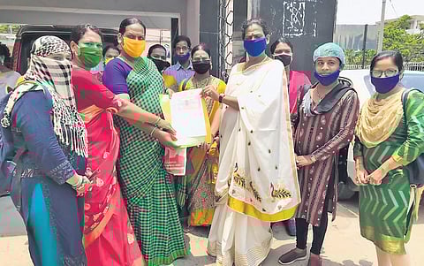 Members of a women SHG receiving the contract agreement on Friday. (Photo| EPS)