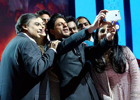 Actor Shahrukh Khan takes a selfie with RIL Chairman Mukesh Ambani and his family during the launch of Reliance Jio 4G services in Mumbai. (File Photo | PTI)