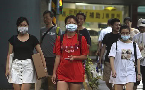 People wear face masks to protect against the spread of the coronavirus. (Photo | AP)