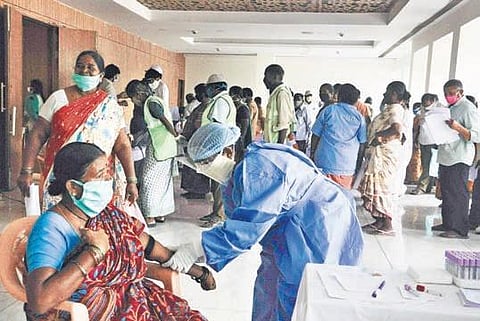 Medical teams conducting blood tests on sanitation workers at Tummalapalli Kalashetram in Vijayawada on Saturday | Prasant Madugula