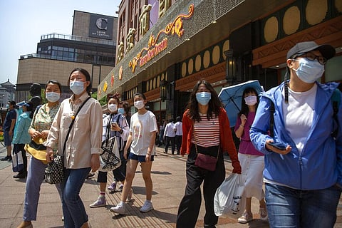 People wearing face masks to protect against the new coronavirus walk outside of a shopping mall at a pedestran shopping street in Beijing, Saturday, June 6, 2020. (Photo | AP)