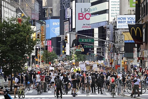 Protesters march through the streets of Manhattan, New York, Sunday, June 7, 2020. New York City lifted the curfew spurred by protests against police brutality ahead of schedule Sunday after a peaceful night, free of the clashes or ransacking of stores th