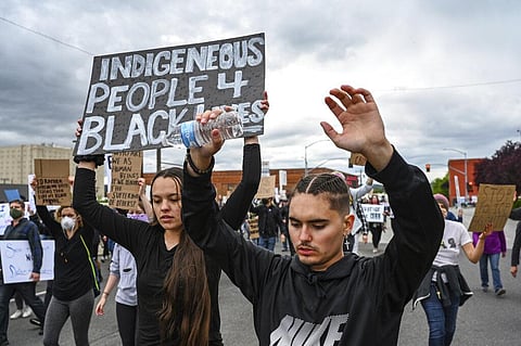 To the chants of 'hands up,' protesters march along Boone Avenue in support of Black Lives Matter in downtown Spokane, Wash., Sunday, June 7, 2020. (Photo | AP)