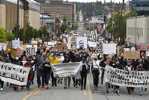 Protesters march up Monroe Street during a Black Lives Matter protest organized by Occupy Spokane and the NAACP, in downtown Spokane, Wash., Sunday, June 7, 2020. (Photo | AP)