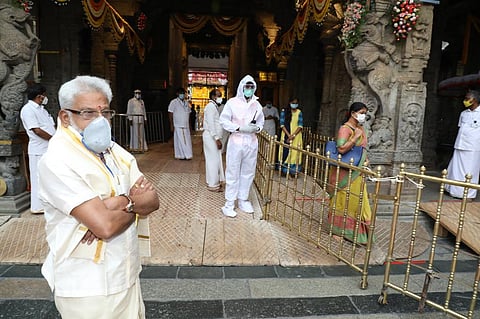 Employees with tokens entering the temple through the Vaikuntam complex. (Photo | EPS)