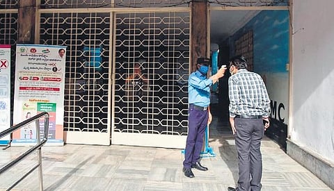 A GHMC official being screened at the entrance of the office after one employee tested positive for Coronavirus at GHMC head office on Monday| Vinay Madapu