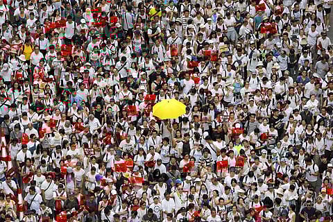 A protester holds up a yellow umbrella as he marches with thousands in a rally against the proposed amendments to extradition law in Hong Kong in June last year. A year ago, a sea of humanity _ a million people by some estimates _ marched through central
