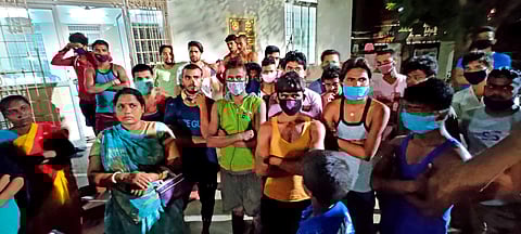 Migrants gathered outside the shelter in Mogappair West. (Photo | Shiba Prasad Sahu, EPS)