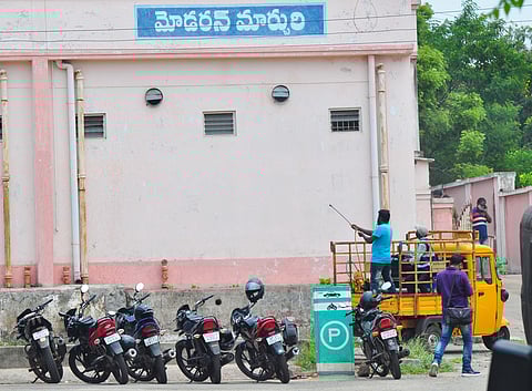 GVMC staff sprinkled disinfectants at KGH mortuary in Visakhapatnam. (Photo | G Satyanarayana, EPS)