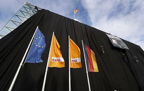 Activists of Greepeace have covered the headquarters of German Chancellor Angela Merkel's Cristian Democratic Party with black panels to protest against the party's coal policy in Berlin. (Photo | AP)