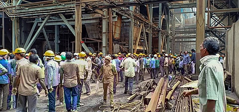Workers stand outside Neyveli Lignite Corporation power plant following an explosion, in Cuddalore district. (Photo | PTI)