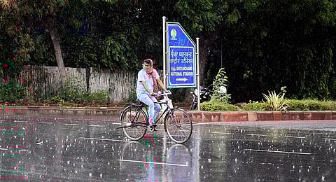 A commuter seen during rain as the capital gets monsoon shower at India Gate on June 26, 2020 in New Delhi. (Photo | Parveen Negi, EPS)