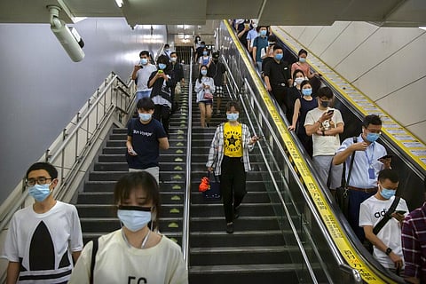 Commuters wearing face masks to protect against the spread of the new coronavirus walk through a subway station in Beijing, Thursday, July 9, 2020. (Photo | AP)
