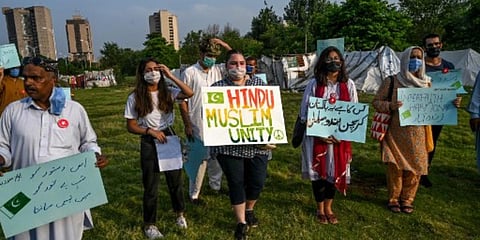 Demonstrators hold placards during a protest in Islamabad as they demand the government to allow the construction of a Hindu temple. (Photo| AFP)