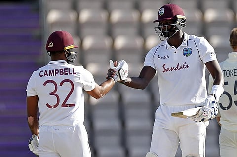 West Indies' Jason Holder (R) and West Indies' John Campbell (L) celebrate after West Indies win the test match on the fifth day of the first Test cricket match between England and the West Indies (Photo| AFP)