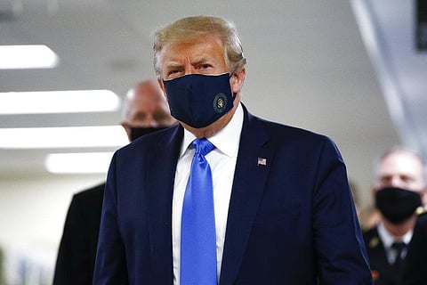 President Donald Trump wears a mask as he walks down the hallway during his visit to Walter Reed National Military Medical Center in Bethesda, Md., Saturday, July 11, 2020. (Photo | AP)