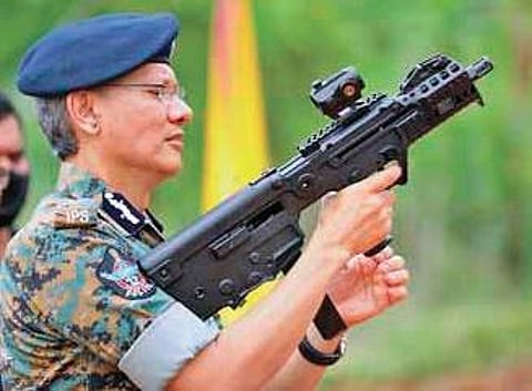 DGP Gautam Sawang tests an advanced pistol from Israel during his visit to the firing range in sixth APSP battalion at Mangalagiri on Saturday I Express