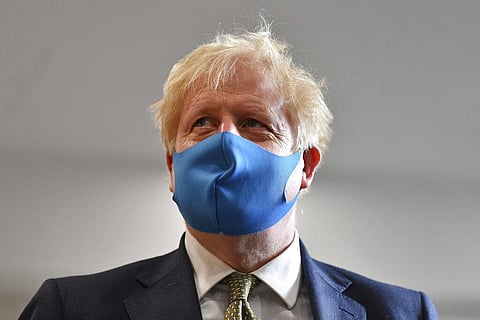 Britain's Prime Minister Boris Johnson, wearing a face mask, visits the headquarters of the London Ambulance Service NHS Trust in London, Monday. (Photo | AP)