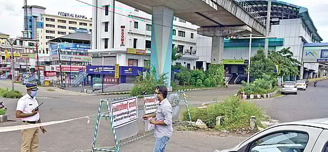A police officer speaks to a commuter looking to enter a containment zone in Aluva. (Photo | EPS/Albin Mathew)
