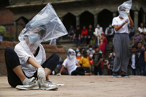Nepalese youth perform a play as part of a protest demanding better COVID-19 management at Patan Durbar Square near Kathmandu. (Photo | AP)