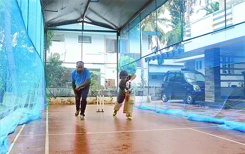 AR Madhavan along with his coach Veerendrakumar practicing cricket at his home near Kuthiravattam in Kozhikode. (Photo | TP Sooraj, EPS)