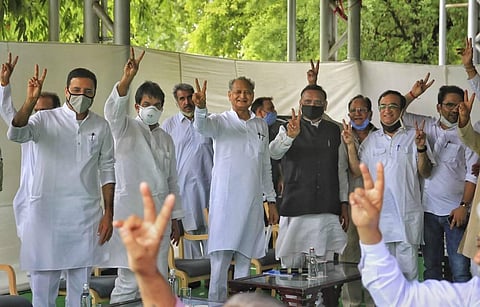 Rajasthan Chief Minister Ashok Gehlot (C) with senior Congress leaders Randeep Surjewala, Avinash Pandey, Ajay Maken and K.C. Venugopal flashes victory sign during a meeting with the party MLAs at his residence in Jaipur Monday July 13 2020. (Photo | PTI)