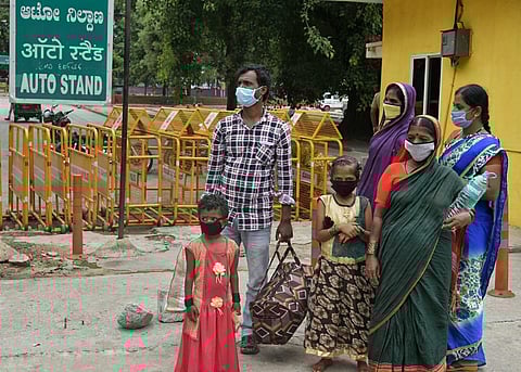 Passengers at KSR railway station in Bengaluru wait for transportation on Wednesday morning (Express Photo | Meghana Sastry)