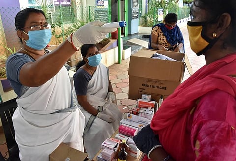 Health staff of Coimbatore City Corporation distributing medicines to the residents of Vysial Street during the fever Surveillence camp in Coimbatore. (Photo | U Rakesh Kumar/EPS)