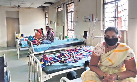 OGH patients sit beside the body of a man who is suspected to have died of Covid