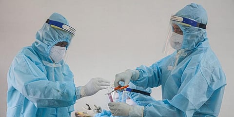 Medics prepare to collect swab samples for COVID-19 testing. (Photo | PTI)