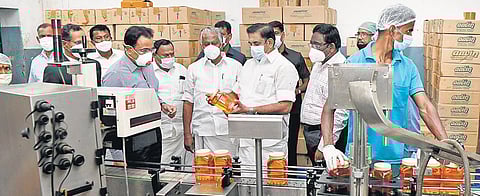Chief Minister Edappadi K Palaniswami inspecting a ghee-making section at Aavin complex in Krishnagiri on Wednesday