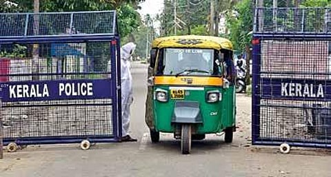 With fear of community spread lingering over Chellanam, a police official clad in a PPE is seen on the road leading to the coastal area | Albin Mathew