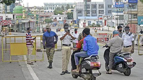 With the lockdown curbs in force, traffic police stop motorists to check for violations on Mysuru Road in Bengaluru. (Photo | Vinod Kumar T, EPS)