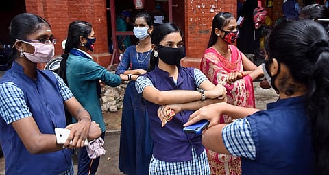 Students celebrating their success in the Class 12 exam through hand-gesturing hug, in Coimbatore on Thursday | A Raja Chidambaram