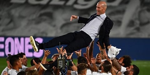 Real Madrid players toss coach Zinedine Zidane after winning the La Liga title. (Photo | AFP)