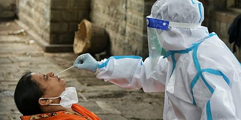 People walk in for COVID-19 test at the fever clinic on JC Road on Friday in Bengaluru. (Photo| Meghana Sastry, EPS)
