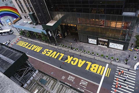 Pedestrians walk on a Black Lives Matter mural painted in front of Trump Tower. (Photo| AP)