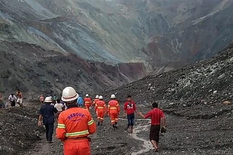 This handout from the Myanmar Fire Services Department taken and released on July 2, 2020 shows rescuers attempting to locate survivors after a landslide at a jade mine in Hpakant, Kachin state. The bodies of at least 50 jade miners were pulled from the m