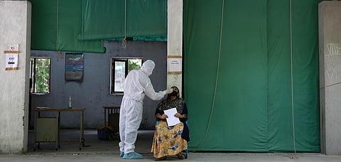 A health worker collects a swab sample for Covid-19 rapid testing at a government school. (Photo | Shekhar Yadav, EPS)