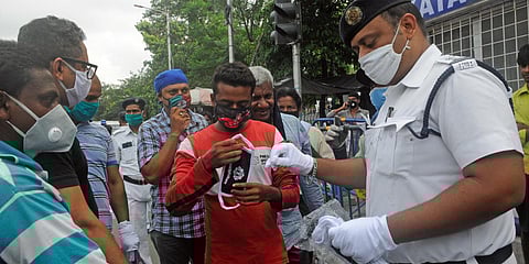 Police distribute masks to people as an awareness campaign amid coronavirus outbreak, in Kolkata. (File photo| ANI)
